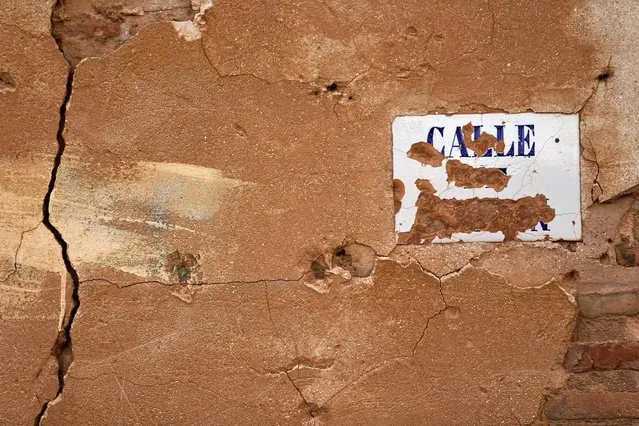 Bullet holes and the remains of a street sign are seen on a building in the old village of Belchite, in northern Spain, November 13, 2016. (Photo by Andrea Comas/Reuters)