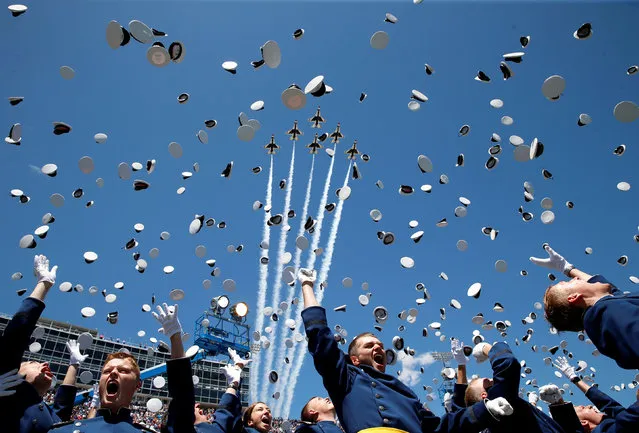 The Thunderbirds perform a fly-over as graduates from the Air Force Academy toss their hats in the air at the conclusion of their commencement ceremony in Colorado Springs, Colorado, June 2, 2016. (Photo by Kevin Lamarque/Reuters)