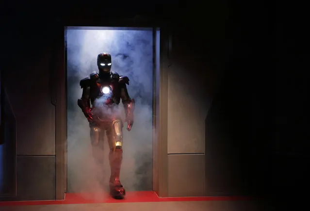 A performer dressed as the Marvel comic character Iron Man arrives at the new attraction “Iron Man Experience” during a media tour in Hong Kong Disneyland, Wednesday, December 14, 2016. Hong Kong Disneyland added an Iron Man-themed area in the hopes that the Marvel superhero's success at the Chinese box office will help draw more visitors to the underachieving resort. The Iron Man Experience include a thrill ride that will let visitors “take flight with Iron Man on an epic adventure” involving a “battle against alien invaders” across Hong Kong. (Photo by Kin Cheung/AP Photo)
