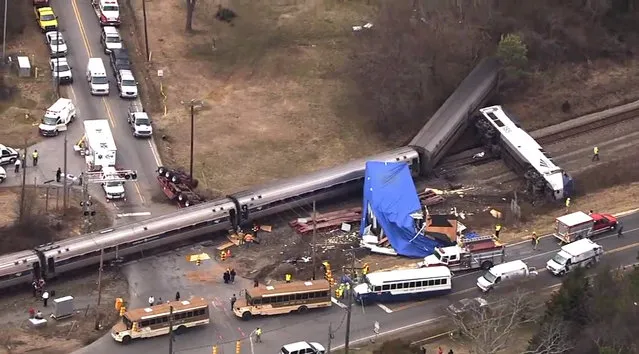 In this frame grab from video provided by WTVD-11, authorities respond to a collision between an Amtrak passenger train and a truck, Monday, March 9, 2015, in Halifax County, N.C. According to Halifax County Sheriff Wes Tripp, none of the injuries appeared to be life-threatening. (AP Photo/WTVD-11)
