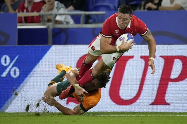 Wales' Josh Adams is tackled by Australia's Mark Nawaqanitawase during the Rugby World Cup Pool C match between Wales and Australia at the OL Stadium in Lyon, France, Sunday, September 24, 2023. (Photo by Christophe Ena/AP Photo)