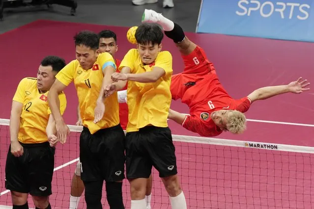 Indonesia's Rusdi Rusdi returns the ball against Vietnam during men's sepaktakraw preliminary Group A match against Indonesia at Jinhua Sports Centre at the 19th Asian Games in Jinhua, China, Sunday, October 1, 2023. (Photo by Eugene Hoshiko/AP Photo)