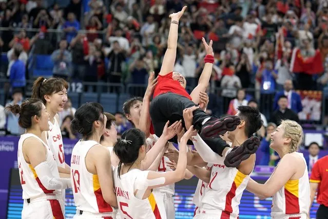 China team toss China's coach Zheng Wei in the air as they celebrate after defeating Japan during the women's Basketball final game at the 19th Asian Games in Hangzhou, China, Thursday, October 5, 2023. (Photo by Lee Jin-man/AP Photo)