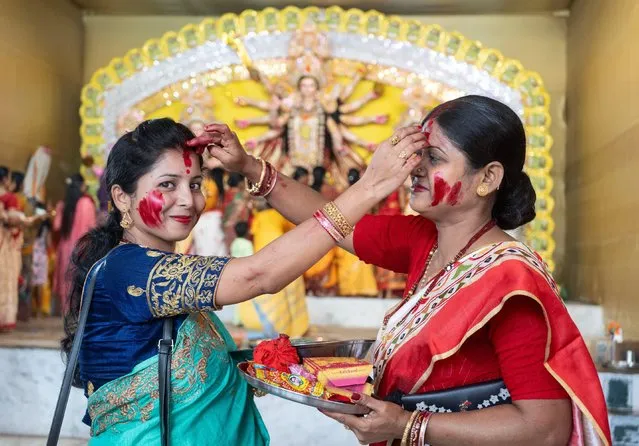 Women plays with Sindoor, as ritual at the end of the Durga Puja festival or Dashami, on October 24, 2023 in Guwahati, Assam, India. Durga Puja is one of the most important festivals in India. (Photo by David Talukdar/ZUMA Press Wire/Alamy Live News)