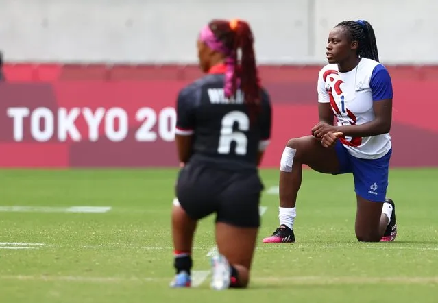Charity Williams of Team Canada and Seraphine Okemba of Team France take a knee before the Women’s pool B match between Team Canada and Team France during the Rugby Sevens on day seven of the Tokyo 2020 Olympic Games at Tokyo Stadium on July 30, 2021 in Chofu, Tokyo, Japan. (Photo by Siphiwe Sibeko/Reuters)