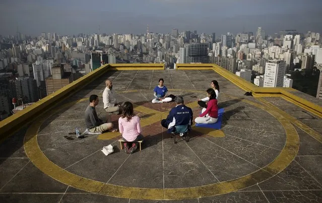 People meditate on the helipad of Copan building to celebrate World Health Day, which was observed on April 7, in downtown Sao Paulo April 9, 2015. (Photo by Nacho Doce/Reuters)