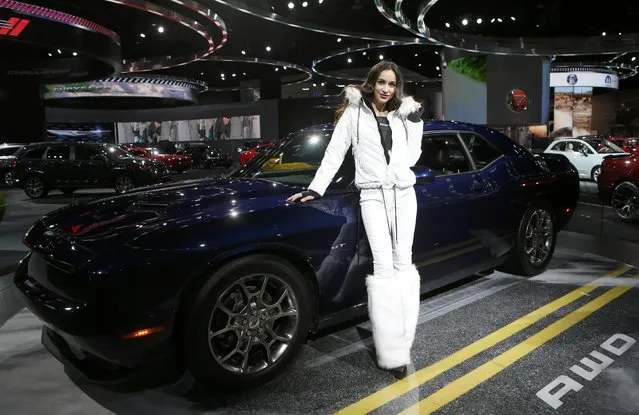 Model Amanda Rodriguez poses with the all-wheel drive 2017 Dodge Challenger during the North American International Auto Show in Detroit, Michigan, U.S., January 10, 2017. (Photo by Rebecca Cook/Reuters)