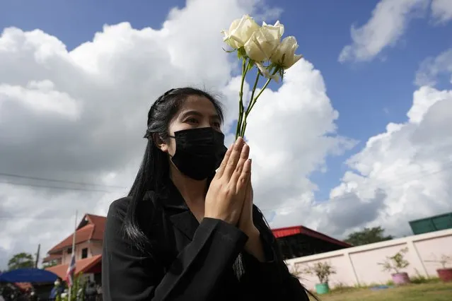 A relative prays during a ceremony for those killed in the attack on the Young Children's Development Center in the rural town of Uthai Sawan, north eastern Thailand, Friday, October 7, 2022. A former policeman facing a drug charge burst into a day care center in northeastern Thailand on Thursday, killing dozens of preschoolers and teachers before shooting more people as he fled in the deadliest rampage in the nation's history. (Photo by Sakchai Lalit/AP Photo)