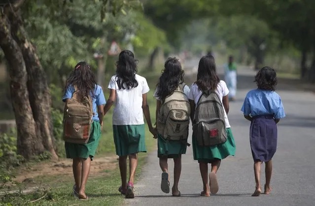Indian girls walk to a school at Burha Mayong village about 45 kilometers (28 miles) east of Gauhati, India, Thursday, April 9, 2015. (Photo by Anupam Nath/AP Photo)