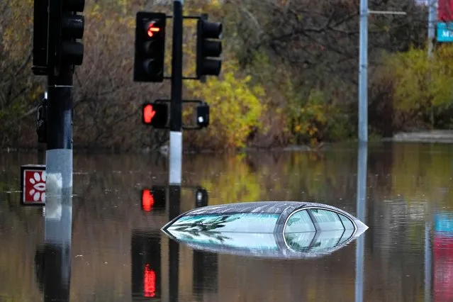 A car sits along a flooded road during a rain storm Monday, January 22, 2024, in San Diego. Heavy rainfall around the U.S. on Monday prompted first responders in Texas to conduct water rescues and officials in California to issue evacuation warnings over potential mudslides in parts of Los Angeles County. (Photo by Gregory Bull/AP Photo)