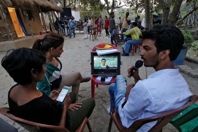 Director Pathikrit Basu explains a scene to actress Rupsha Mukherjee (2nd L) and a crew member on the set of Bengali movie “Ke Tumi Nandini” in Kolkata, February 21, 2019. (Photo by Rupak De Chowdhuri/Reuters)