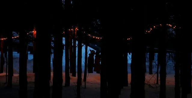 A couple is seen in the forest at Domaine de la Foret Perdu or the Lost Forest, a 15km weaving and zambonied forest trail made for skating in Notre-Dame-du-Mont-Carmel, near Three Rivers, Quebec January 29, 2017. (Photo by Christinne Muschi/Reuters)