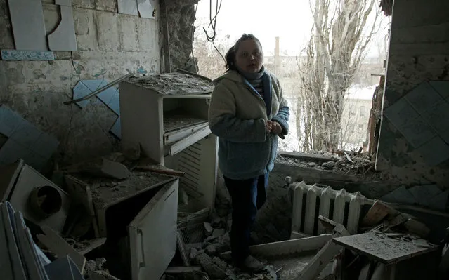 A woman stands amidst the debris of her damaged apartment, which according to locals was caused by recent shelling, in Donetsk, Ukraine, February 1, 2017. (Photo by Alexander Ermochenko/Reuters)
