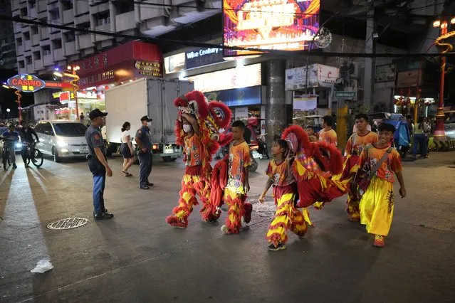 Lion performers cross a road at Binondo district, said to be the oldest Chinatown in the world, in Manila, Philippines on Tuesday, February 6, 2024. (Photo by Aaron Favila/AP Photo)