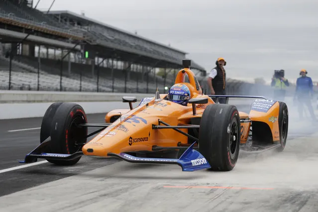 IndyCar driver Fernando Alonso, of Spain, drives out of the pit area during testing at the Indianapolis Motor Speedway in Indianapolis, Wednesday, April 24, 2019. (Photo by Michael Conroy/AP Photo)