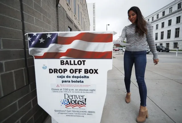 Rosa Amaya of Denver drops off drop off ballots at the Denver Electoral Commission Tuesday, May 7, 2019, in Denver. Voters could make Denver the first U.S. city to decriminalize the use of psilocybin, the psychoactive substance in “magic mushrooms” if the measure passes. (Photo by David Zalubowski/AP Photo)