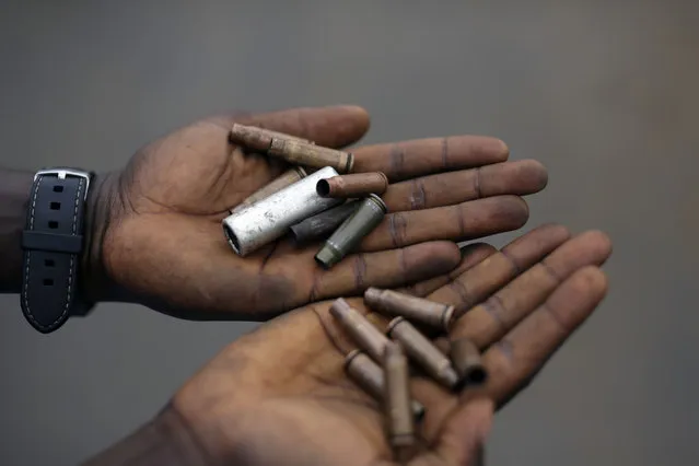 Demonstrators display cartridges from police guns fired in the Musaga neighborhood of Bujumbura, Burundi, Wednesday May 20, 2015. (Photo by Jerome Delay/AP Photo)