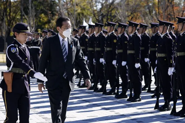 Japan's Prime Minister Fumio Kishida, second left, reviews an honor guard at the Japan Ground Self-Defense Force Camp Asaka in Tokyo, Japan, Saturday, November 27, 2021. (Photo by Kiyoshi Ota/Pool Photo via AP Photo)