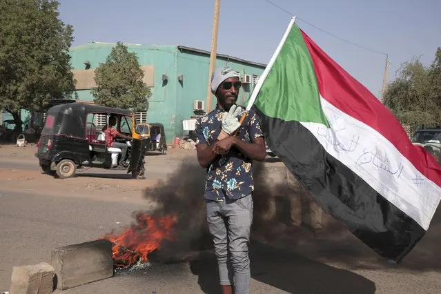 People protests against the October military coup and subsequent deal that reinstated Prime Minister Hamdok in Khartoum, Sudan, Monday, December 6, 2021. (Photo by Marwan Ali/AP Photo)