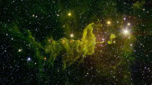 This NASA image obtained April 15, 2016 shows The spider part of The Spider and the Fly nebulae, IC 417 in star formation, as seen in this infrared image from NASA's Spitzer Space Telescope and the Two Micron All Sky Survey (2MASS). Located in the constellation Auriga, IC 417 lies about 10,000 light-years away. It is in the outer part of the Milky Way, almost exactly in the opposite direction from the galactic center. (Photo by AFP Photo/NASA)