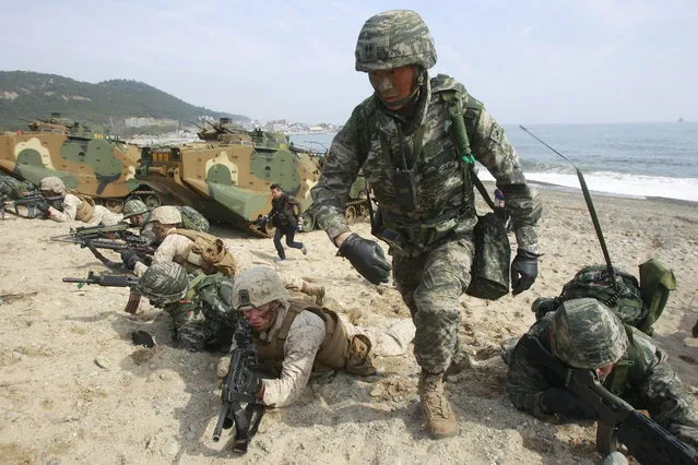 South Korean and U.S. Marines participate in the U.S.-South Korea joint landing exercises called Ssangyong, part of the Foal Eagle military exercises, in Pohang, South Korea, Monday, March 31, 2014. (Photo by Jung Yeon-Je/AFP Photo)