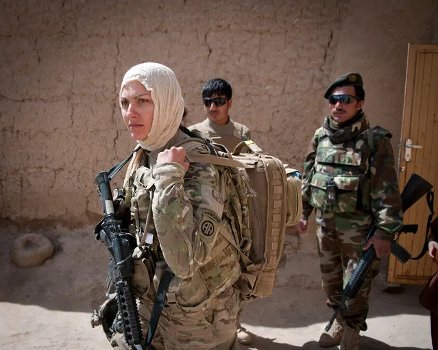 Pfc. Kristina Batty, a medic with the 82nd Airborne Division’s 1st Brigade Combat Team, dons a headscarf to meet with female Afghan villagers May 5, 2012, Ghazni Province, Afghanistan. Batty is joining Female Engagement Team members to discover what females of the village need. (Photo by Sgt. Michael J. MacLeod/U.S. Army)