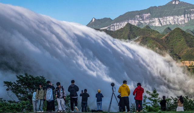 Water vapour cascades down the Gold Buddha Mountain after a rainfall, drawing large crowds of visitors, on May 13, 2024 in Chongqing, China. (Photo by Qu Mingbin/VCG via Getty Images)