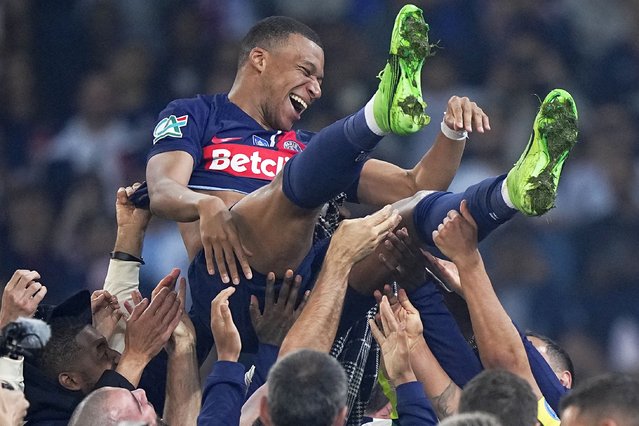 PSG's Kylian Mbappe is tossed into the air as he celebrates with teammates after the French Cup final soccer match between Lyon and PSG at the Pierre Mauroy stadium in Villeneuve d'Ascq, northern France, Saturday, May 25, 2024. PSG won the match 2-1. (Photo by Michel Euler/AP Photo)