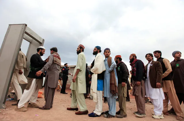 Men pass through a security check point at the shrine built over the grave of Mumtaz Qadri during a gathering to mark his death anniversary outside Islamabad, Pakistan, March 1, 2017. (Photo by Faisal Mahmood/Reuters)