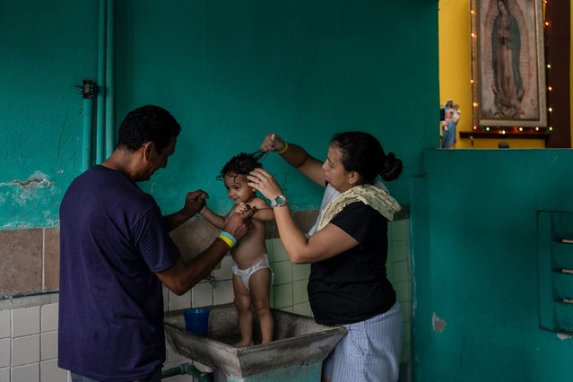 Venezuelan migrants Hernán Sánchez and Rosana Mercado bathe their daughter inside a shelter in Villahermosa, Mexico, on Friday, June 7, 2024. After the head of Mexico's immigration agency ordered a halt to deportations in December, migrants have been left in limbo as authorities round up migrants across the country and dump them in the southern Mexican cities of Villahermosa and Tapachula. (Photo by Felix Marquez/AP Photo)