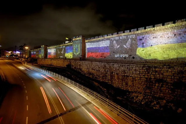The national flags of Russia and Ukraine are projected on the walls of Jerusalem's Old City, which a spokesperson from the Jerusalem Municipality said is a show of support for diplomatic dialogue between the countries, amid Russia's invasion of Ukraine, in Jerusalem, March 13, 2022. (Photo by Ammar Awad/Reuters)