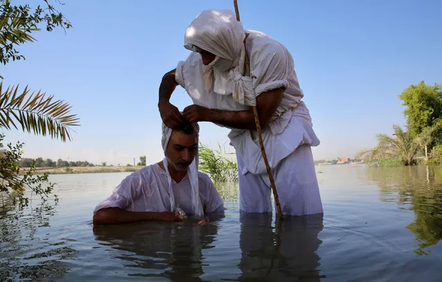 Mandean men, known in Arabic as Sabean, take part in the “great feast” or the Mandaean new year rituals in Baghdad on July 17, 2019. The Sabeans, originally from southern and southeastern Iraq, say their religion is pre-Christian even though they revere John the Baptist. Today the number has dwindled to some 5000 who live in Iraq and are officially recognised as a separate religion. (Photo by Sabah Arar/AFP Photo)