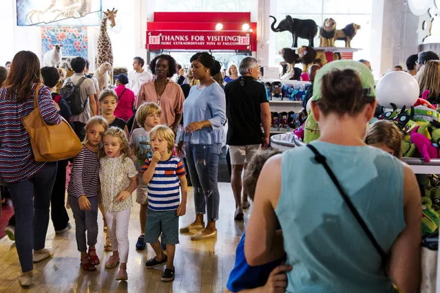 Children react as they walk into the toy store July 15, 2015. (Photo by Lucas Jackson/Reuters)
