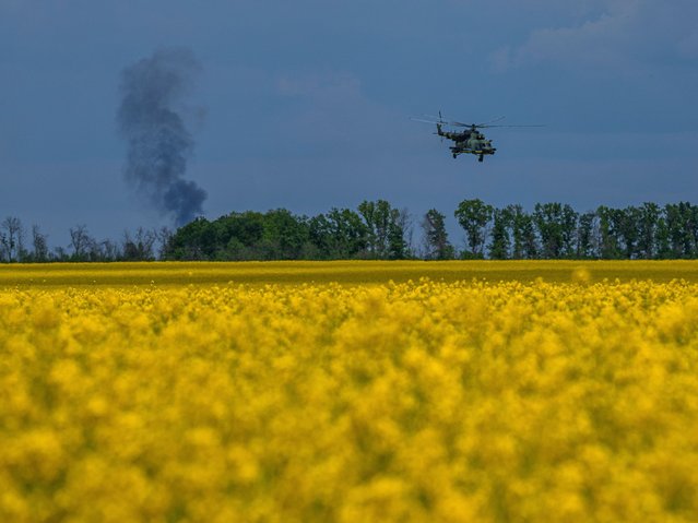 A Ukrainian Mi-8 helicopter returns from a combat operation at the frontline in Kharkiv region, Ukraine, Sunday, May 19, 2024. According to officials, several people were killed in this attack. (Photo by Evgeniy Maloletka/AP Photo)