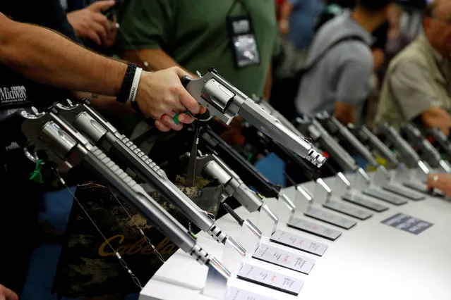 Attendees visit the trade booths during the National Rifle Association's annual meeting in Louisville, Kentucky, May 21, 2016. (Photo by Aaron P. Bernstein/Reuters)