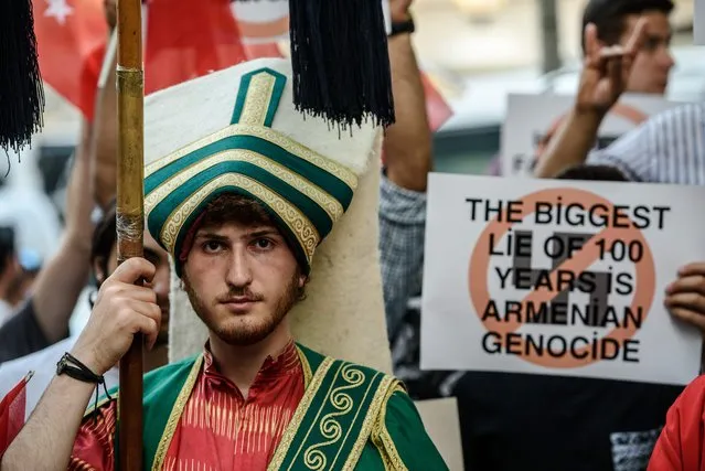 A Turkish nationalist protester wearing Ottoman clothes holds placard during a protest against Germany on June 2, 2016 in front of the Germany consulate in Istanbul after German parliament labelled the World War I massacre of Armenians by Ottoman forces as genocide. Turkish President Recep Tayyip Erdogan on June 2 warned that the German parliament's recognition of World War I killings of Armenians by Ottoman forces as genocide would “seriously affect” ties. (Photo by Ozan Kose/AFP Photo)