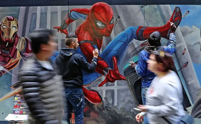 Apparition Media artists David Pereirra and Tayla Broekman paint the final parts of the Spider-Man: Homecoming mural on June 8, 2017 in Melbourne, Australia. Apparition Media were commissioned by Sony Pictures to paint a mural to celebrate their new movie Spider-Man: Homecoming. (Photo by Scott Barbour/Getty Images)