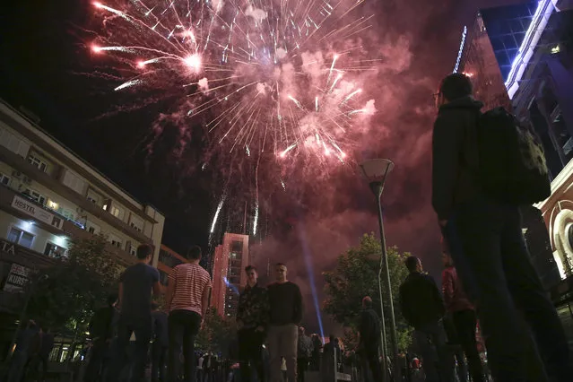 Fireworks illuminate the main square after the coalition of former ethnic Albanian rebel commanders claimed victory in general elections in Kosovo capital Pristina on Monday, June 12, 2017. The coalition of former ethnic Albanian rebel commanders has won the most votes in Kosovo's general election, which also saw a surge in popularity for a nationalist party, according to preliminary results. (Photo by Visar Kryeziu/AP Photo)