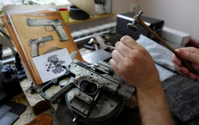 A worker engraves a pistol in the Ceska Zbrojovka weapons factory in Uhersky Brod, Czech Republic, May 27, 2016. (Photo by David W. Cerny/Reuters)