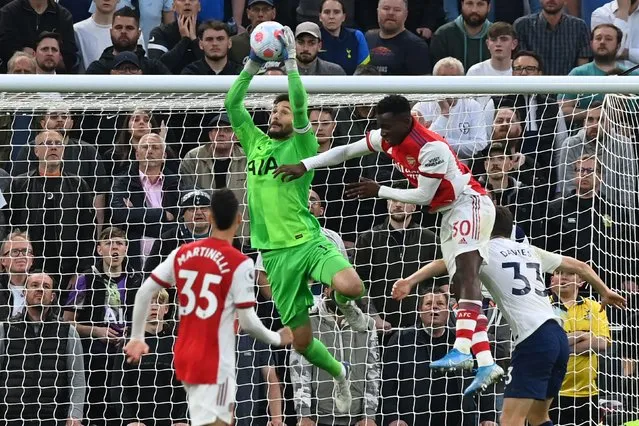 Tottenham Hotspur's French goalkeeper Hugo Lloris catches the ball under pressure from Arsenal's English striker Eddie Nketiah (2nd R) during the English Premier League football match between Tottenham Hotspur and Arsenal at Tottenham Hotspur Stadium in London, on May 12, 2022. (Photo by Glyn Kirk/AFP Photo)