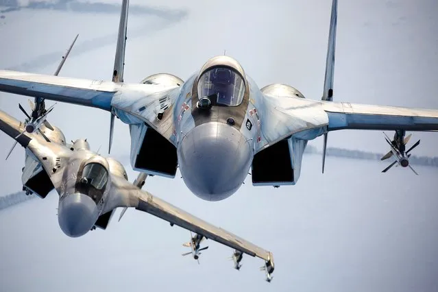 In this photo released by the Russian Defense Ministry Press Service, a pair of Russian Su-35 fighter jets fly in the sky in Russia, November 28, 2021. The amassing of Russian troops and equipment near Ukraine's border has caused worries in Kyiv and in the West that Moscow could be planning to launch an invasion. Russia, the United States and its NATO allies are meeting this week for negotiations focused on Moscow's demand for Western security guarantees and Western concerns about a recent buildup of Russian troops near Ukraine. (Photo by Russian Defense Ministry Press Service via AP Photo, File)