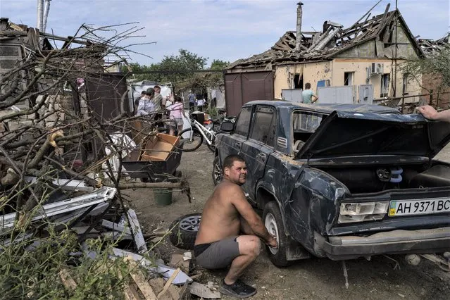 Residents recover belongings from their damaged houses after a missile strike in Druzhkivka, eastern Ukraine, Sunday, June 5, 2022. (Photo by Bernat Armangue/AP Photo)