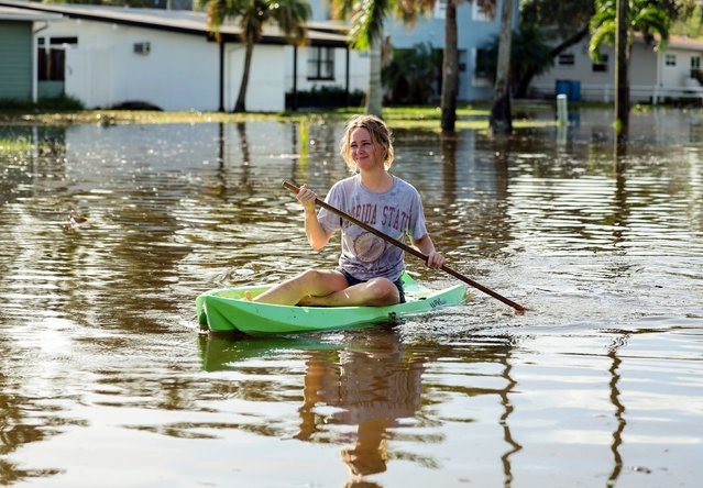 Halle Brooks kayaks down a street flooded by Hurricane Helene in the Shore Acres neighborhood Friday, September 27, 2024, in St. Petersburg, Fla. (Photo by Mike Carlson/AP Photo)