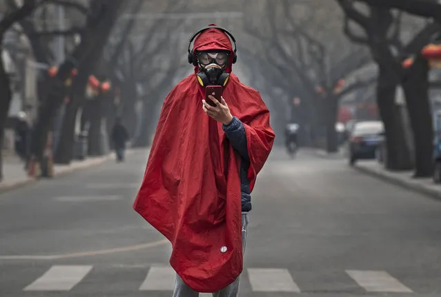 A Chinese man wears a protective mask, goggles and coat as he stands in a nearly empty street during the Chinese New Year holiday on January 26, 2020 in Beijing, China. The number of cases of a deadly new coronavirus rose to over 2000 in mainland China Sunday as health officials locked down the city of Wuhan earlier in the week in an effort to contain the spread of the pneumonia-like disease. Medical experts have confirmed the virus can be passed from human to human. In an unprecedented move, Chinese authorities put travel restrictions on the city, which is the epicenter of the virus, and neighboring municipalities affecting tens of millions of people. The number of those who have died from the virus in China climbed to at least 56 on Sunday, and cases have been reported in other countries including the United States, Canada, Australia, France, Thailand, Japan, Taiwan and South Korea. (Photo by Kevin Frayer/Getty Images)
