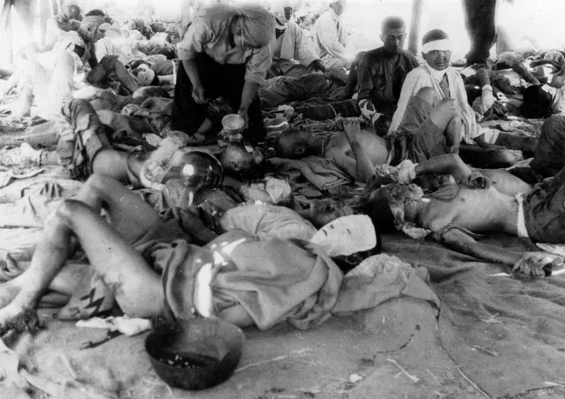 Victims of the atomic bombing of Hiroshima on August 6, 1945 are seen at an emergency relief station in the Otagawa River embankment in Hiroshima, Japan, in this handout photo taken by Yotsugi Kawahara on August 9, 1945 and released by the Hiroshima Peace Memorial Museum. (Photo by Yotsugi Kawahara/Reuters/Hiroshima Peace Memorial Museum)