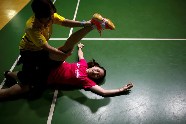 Thailand's badminton player Ratchanok Intanon, who hopes to win gold at the Rio Olympics, receives a massage during a morning training session at a gym in Bangkok, Thailand, June 22, 2016. (Photo by Athit Perawongmetha/Reuters)