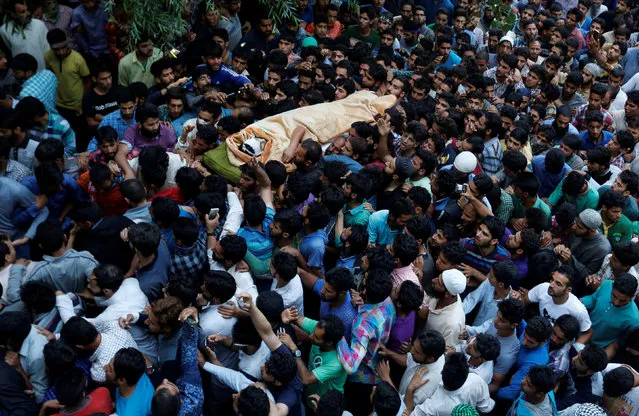 Kashmiri Muslims carry the body of Burhan Wani, a separatist militant leader, during his funeral in Tral, south of Srinagar, July 9, 2016. (Photo by Danish Ismail/Reuters)