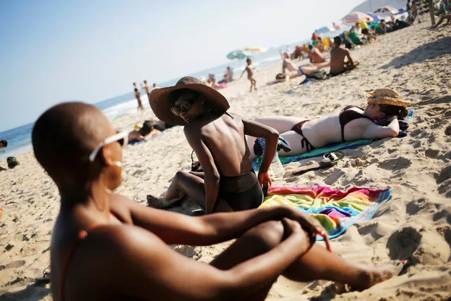 Tourists sunbathe on Ipanema beach in Rio de Janeiro, Brazil, May 3, 2016. (Photo by Nacho Doce/Reuters)