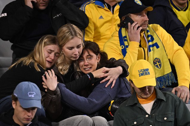 Swedish supporters react as they wait in the stand during the Euro 2024 qualifying football match between Belgium and Sweden at the King Baudouin Stadium in Brussels on October 16, 2023, after an 'attack' that targeted Swedish citizens in a street of Brussels. Belgian federal prosecutor leading on terrorism cases launched an investigation into an attack that left two dead in Brussels on October 16, 2023 evening, a spokesman told AFP. Belgium PM slams Brussels “attack” targeting Swedish citizens. (Photo by John Thys/AFP Photo)