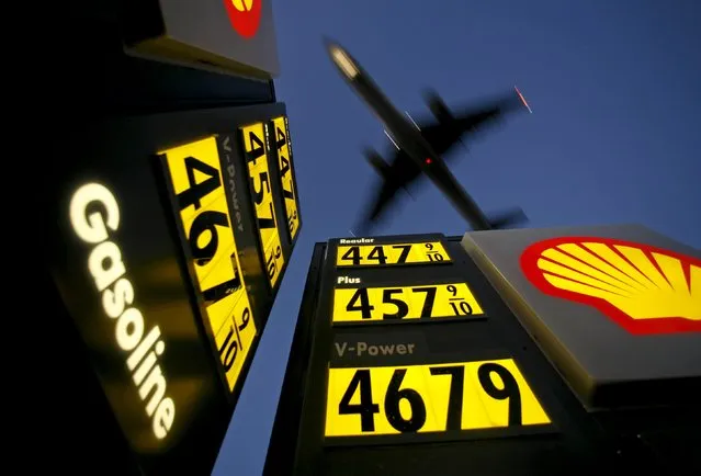 Gasoline prices are advertised at a Shell gas station near Lindbergh Field as a plane approaches to land in San Diego, California, in this June 1, 2008 file photo. Royal Dutch Shell gained EU approval on September 2, 2015 for its $58 billion acquisition of Britain's BG Group, the second of four key markets needed to clear the deal, but faced a slight delay in securing a decision in Australia. (Photo by Mike Blake/Reuters)